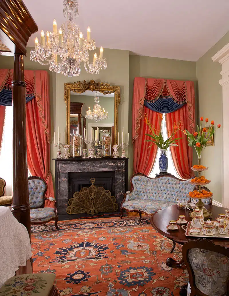 Elegant vintage living room with chandelier and fireplace.